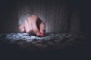 leadership - man holding red puzzle piece