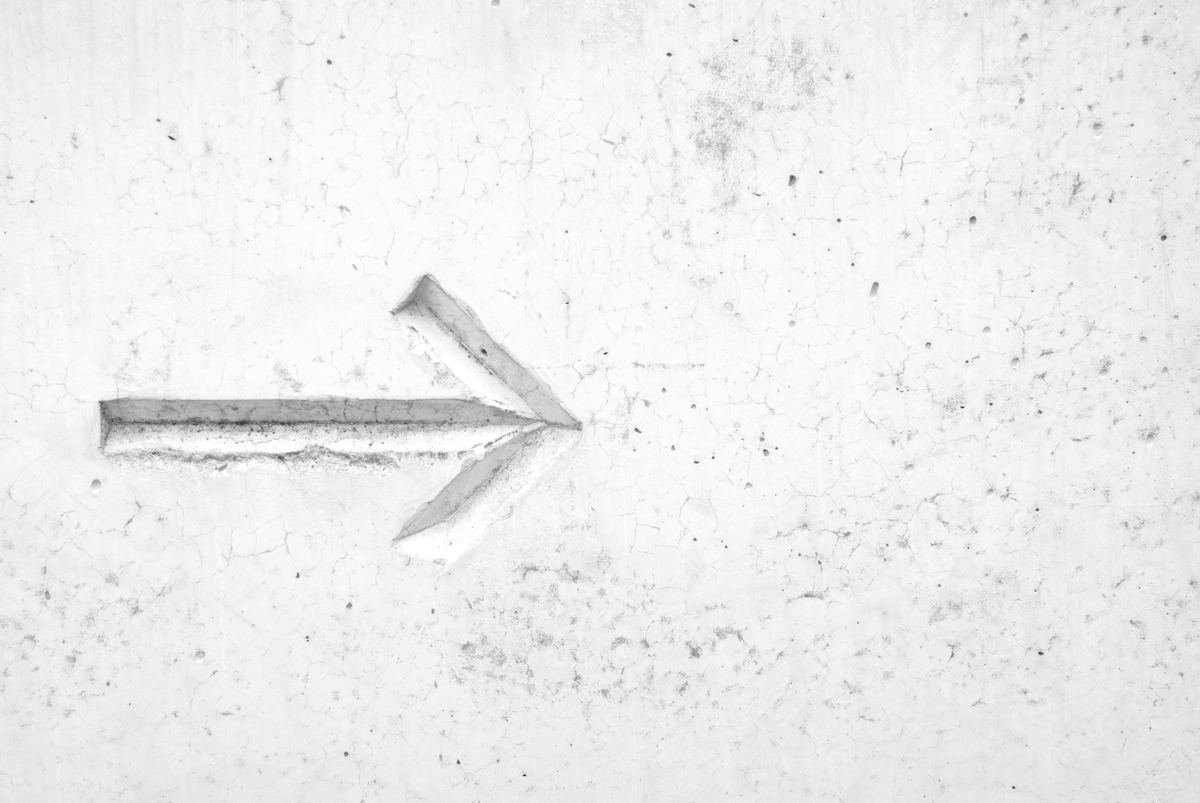 leadership - right arrow etched in concrete