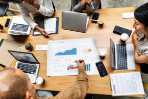 Buyer Personas - Team looking at data and statistics at conference table