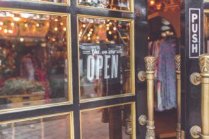 Branding - We are open sign in retail shop window