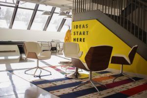 company culture - modern office with yellow wall reading ideas start here
