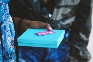 company culture - woman holding blue box with gift card